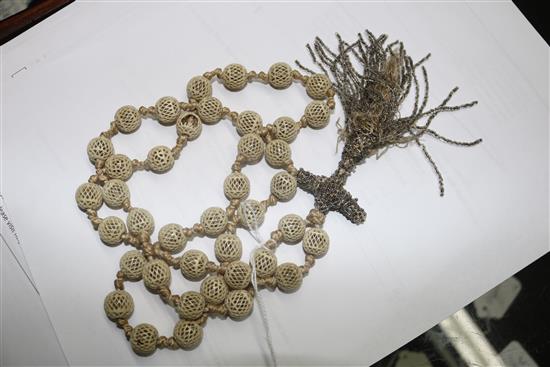 A reticulated ivory bead and tassel drop rosary necklace, 100cm.